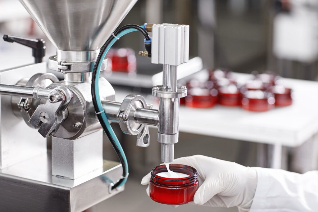 Beauty Manufacturing Facility Filling a Jar with Cream